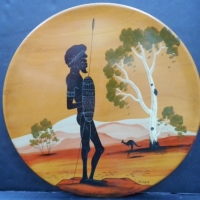 1960s Kauri pine charger of an Aboriginal Warrior signed Wirrin with Bill Onus label - 30cm diameter - Sold for $73 - 2015