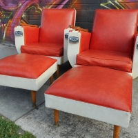 Pair of 1960s orange Vinyl lounge chairs with wooden arms and built in chrome ashtrays and two matching footstools - Sold for $195 - 2015