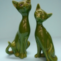 Pair of vintage china Siamese cats - stylish elongated forms with olive green glaze - no makers marks sighted, minor nibbles to ears & nose - approx 1 - Sold for $37 - 2015