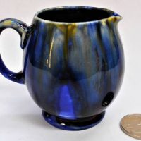 Small Moorcroft pottery jug in blue blaze with impressed mark to base - 8cm H - Sold for $37 - 2019