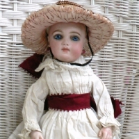 French 1880's  BRU JNE Bebe bisque DOLL, kid body, glass eyes, bisque hands, forearms, orig. earrings & clothing, orig. BRU shoes & wardrobe of orig clothing -14" long, no wig, marks incl. no 3 - sold for  $7442 (archives)